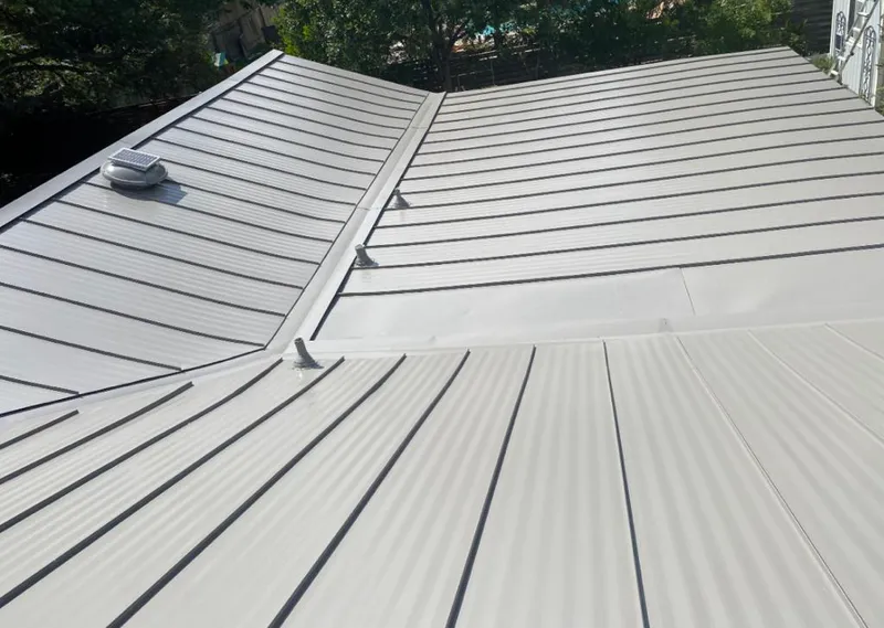 Solar attic fan installed on a metal roof for Roof Ventilation in Peninsula